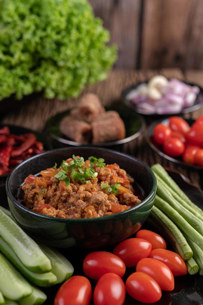 Sweet pork bowl with cucumbers, long beans and tomatoes photo