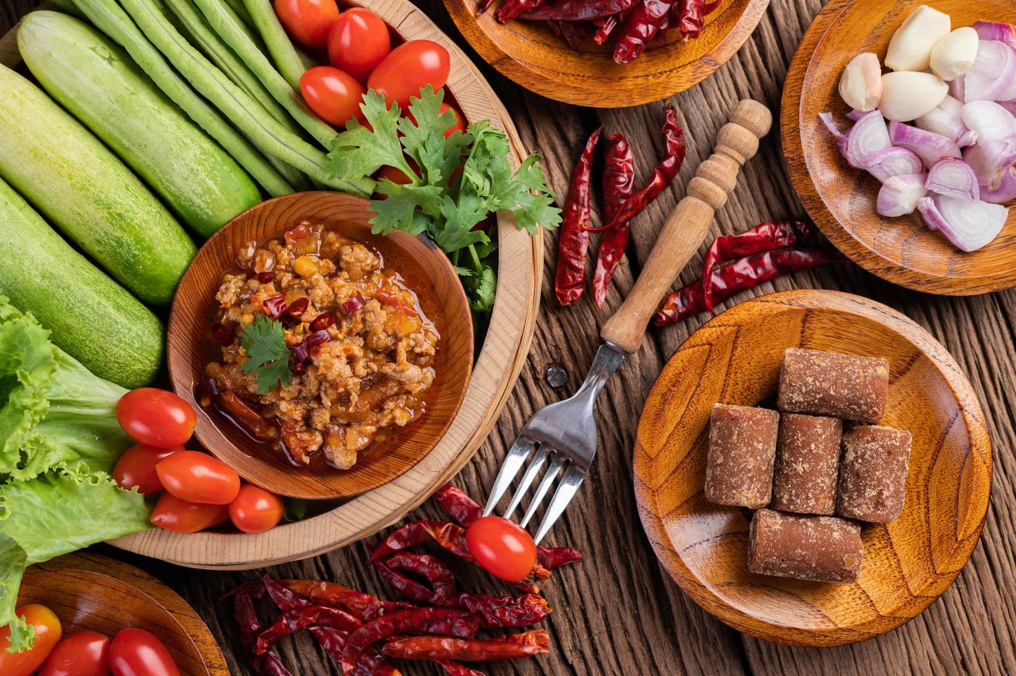 Sweet pork in a wooden bowl with ingredients photo