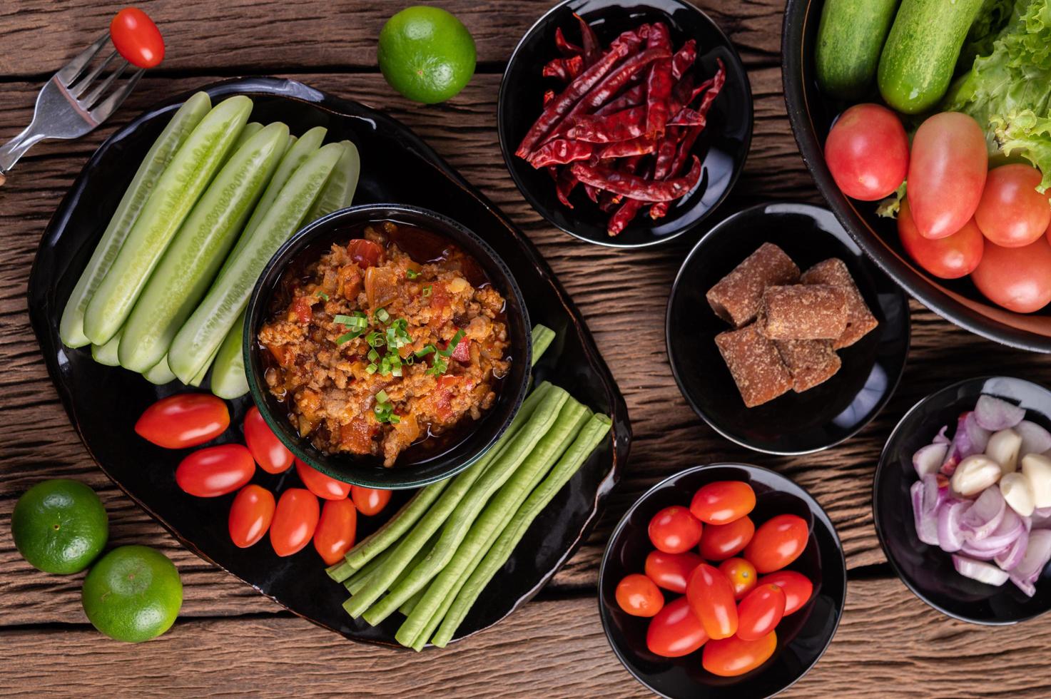 Sweet pork bowl with cucumbers, long beans and tomatoes photo