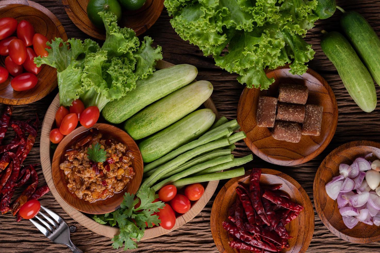 Sweet pork in a wooden bowl with ingredients photo