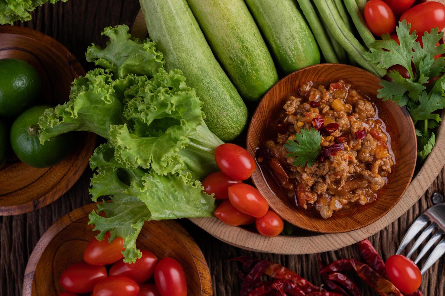 Sweet pork in a wooden bowl with ingredients photo