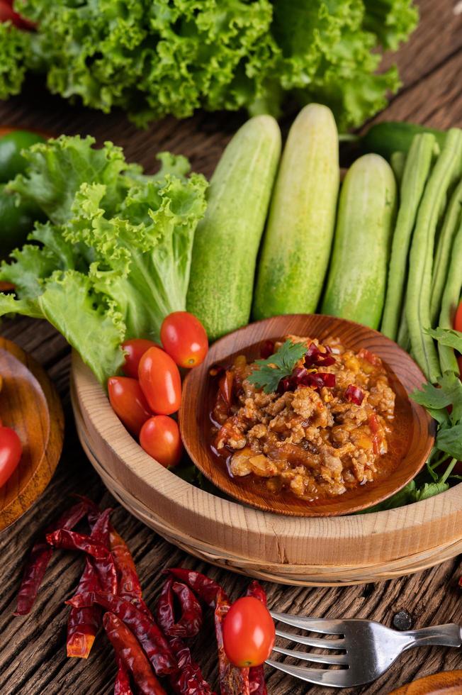 Sweet pork in a wooden bowl with ingredients photo