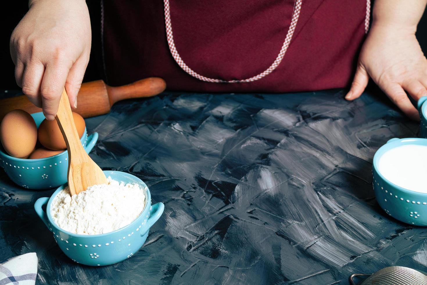 Person stirring flour in a bowl photo