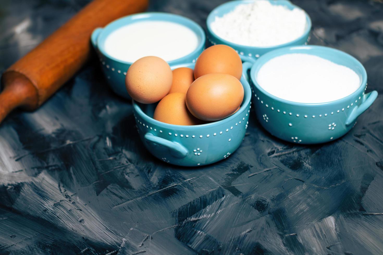 Blue bowls of baking ingredients photo