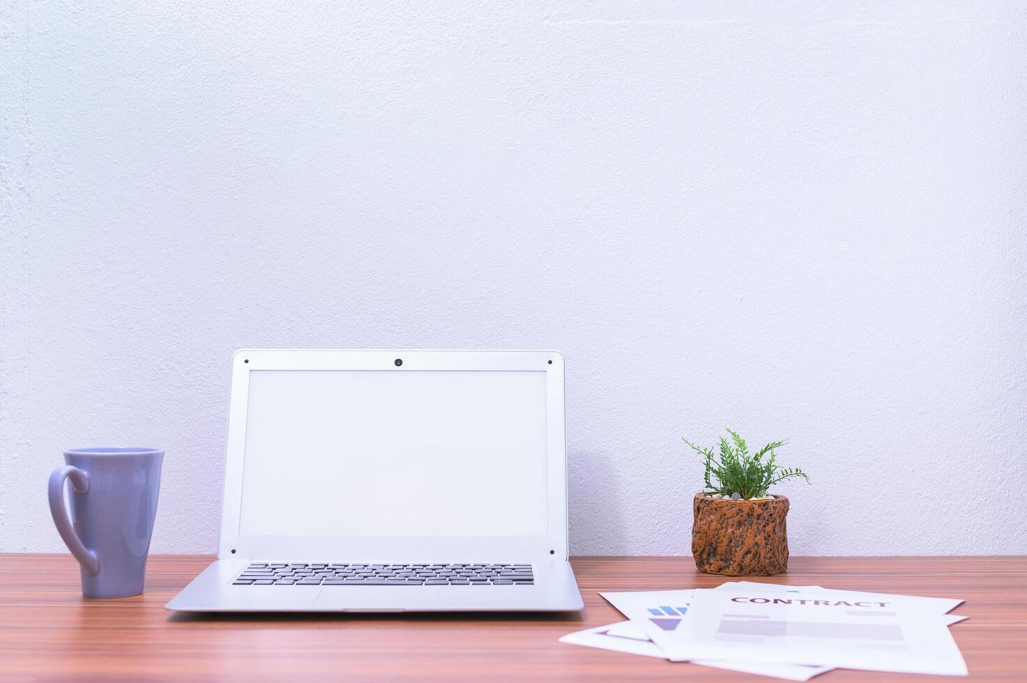 Laptop computer and flower on the desk photo