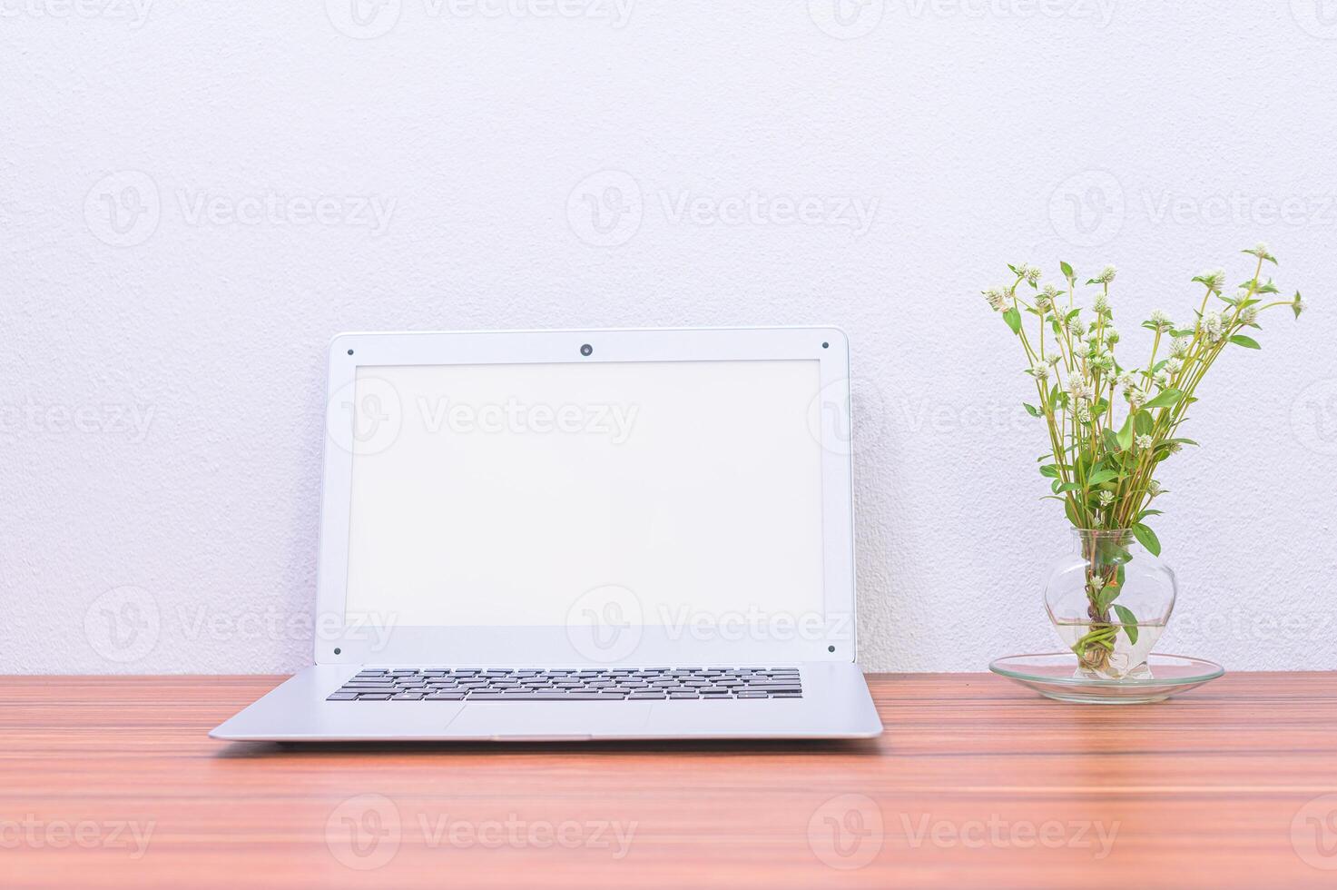 Laptop with blank screen on wooden table photo