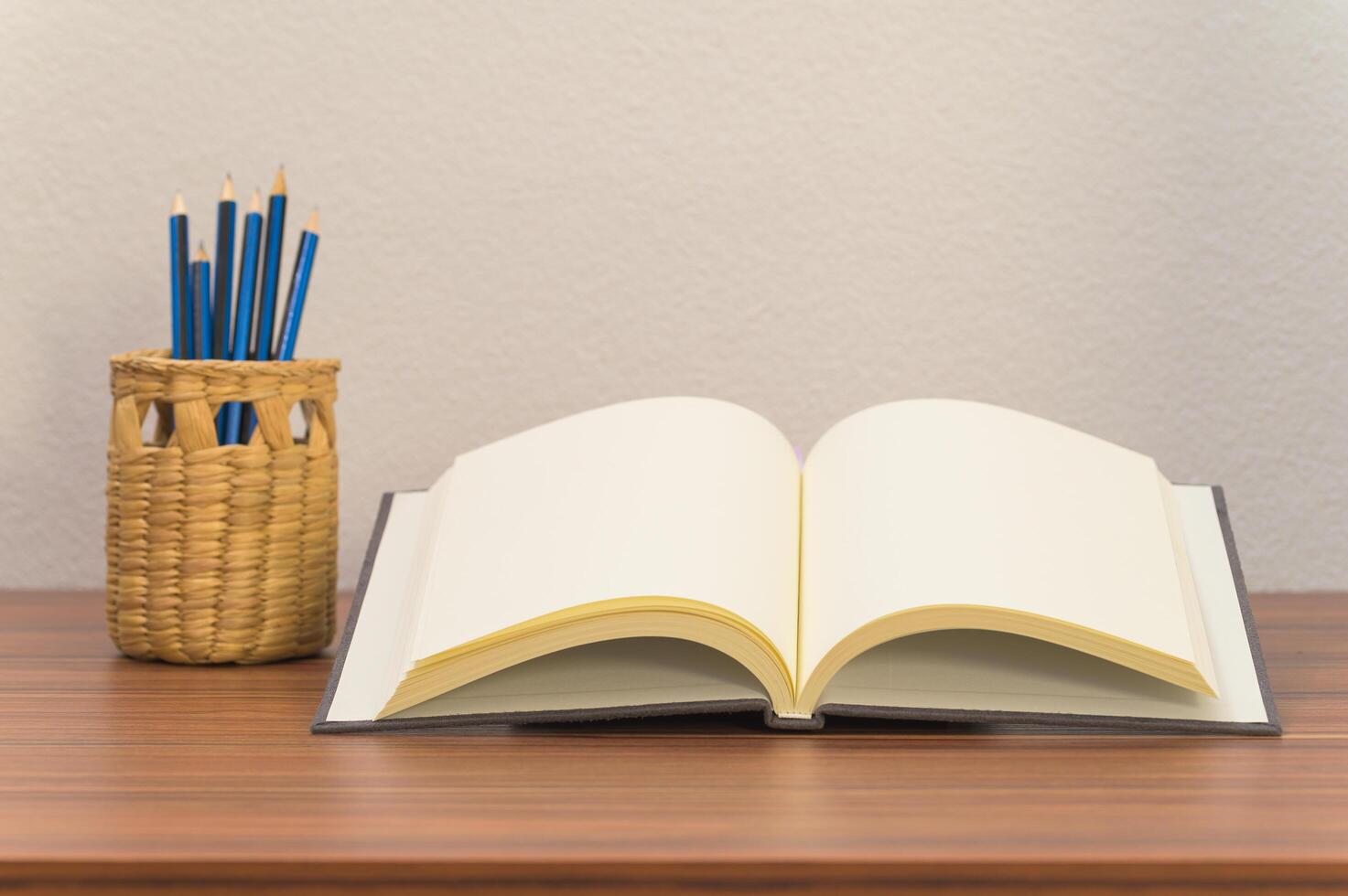 Book and pencils on the desk photo