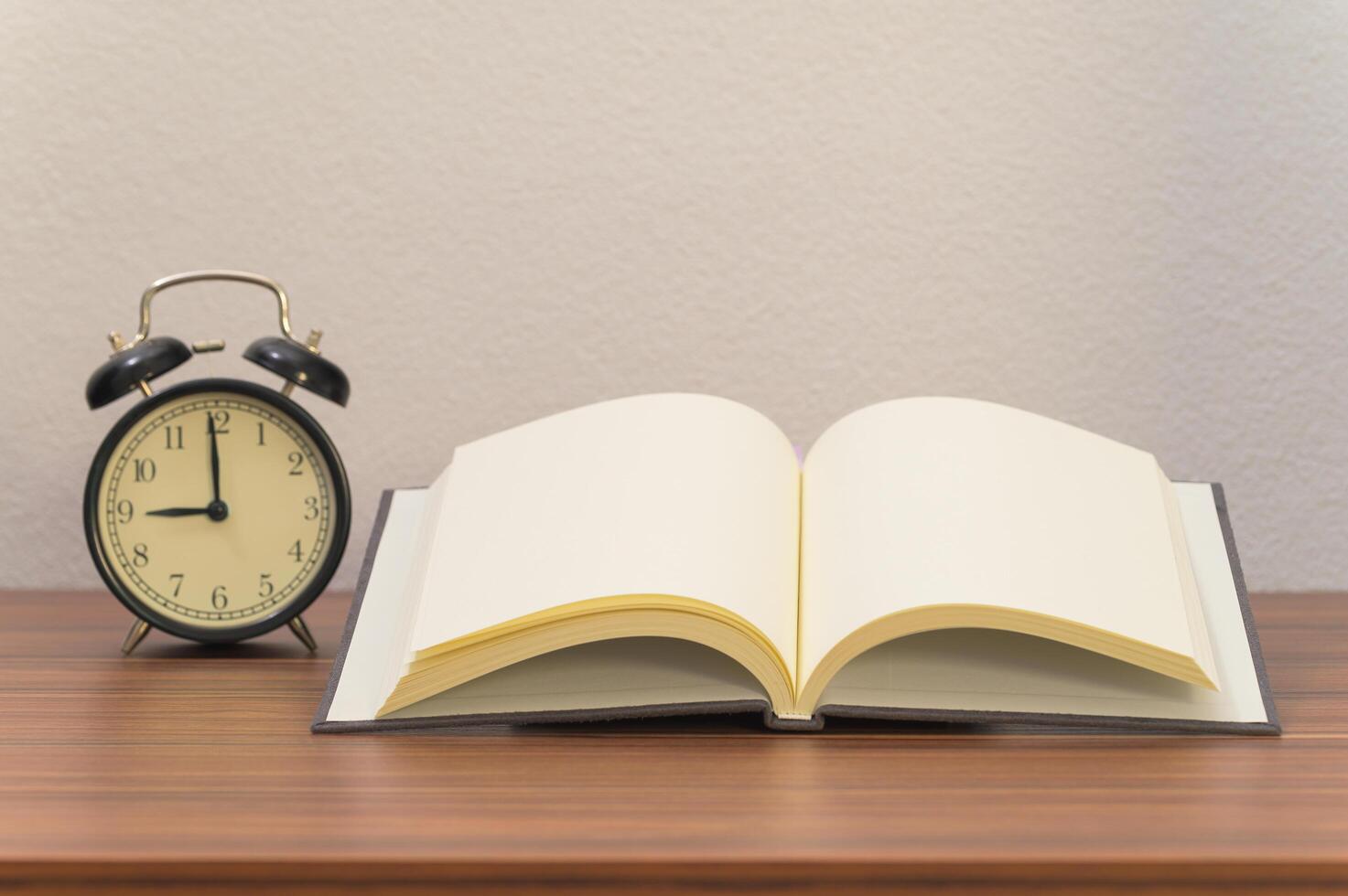 Book and alarm clock the desk photo