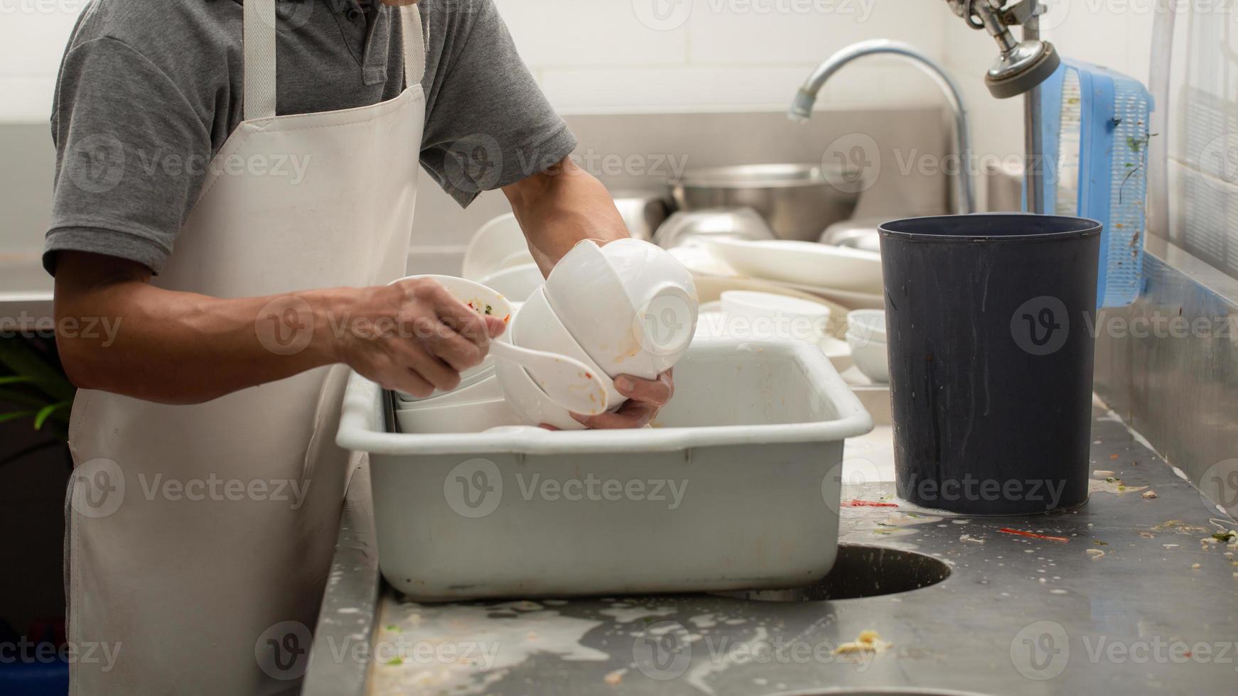 Man washing dishes photo