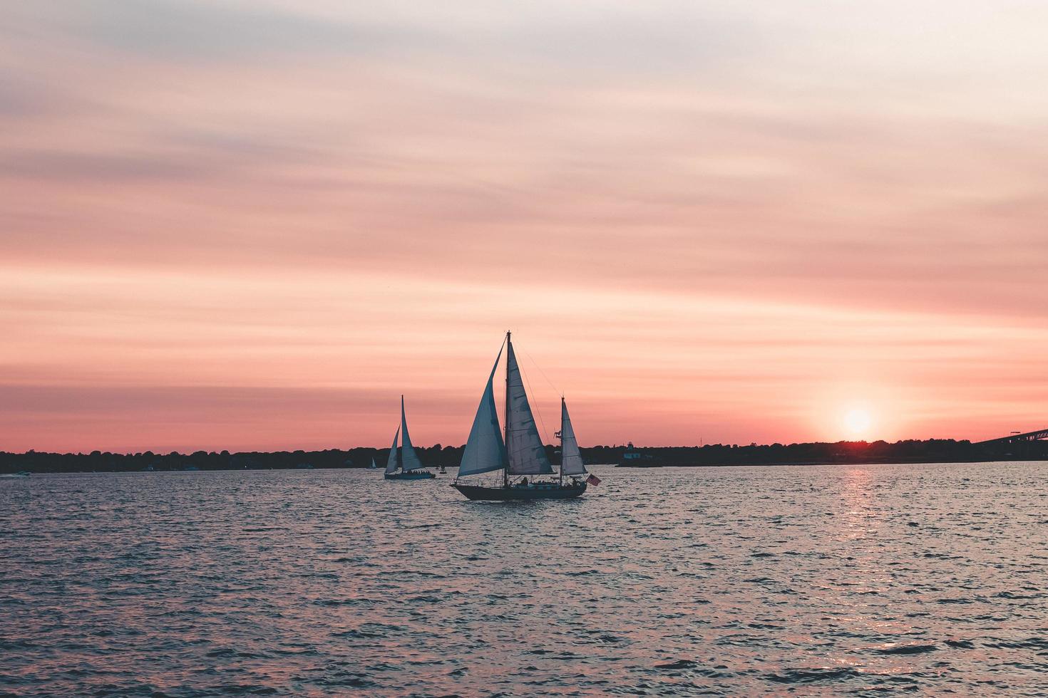 Sailboats at sunset photo