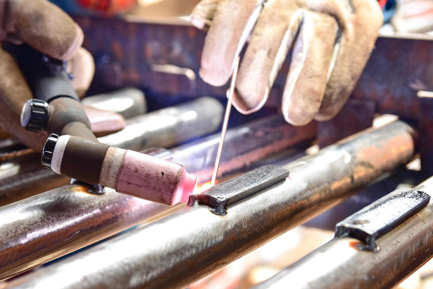 The welder is welding the plate to the pipe photo