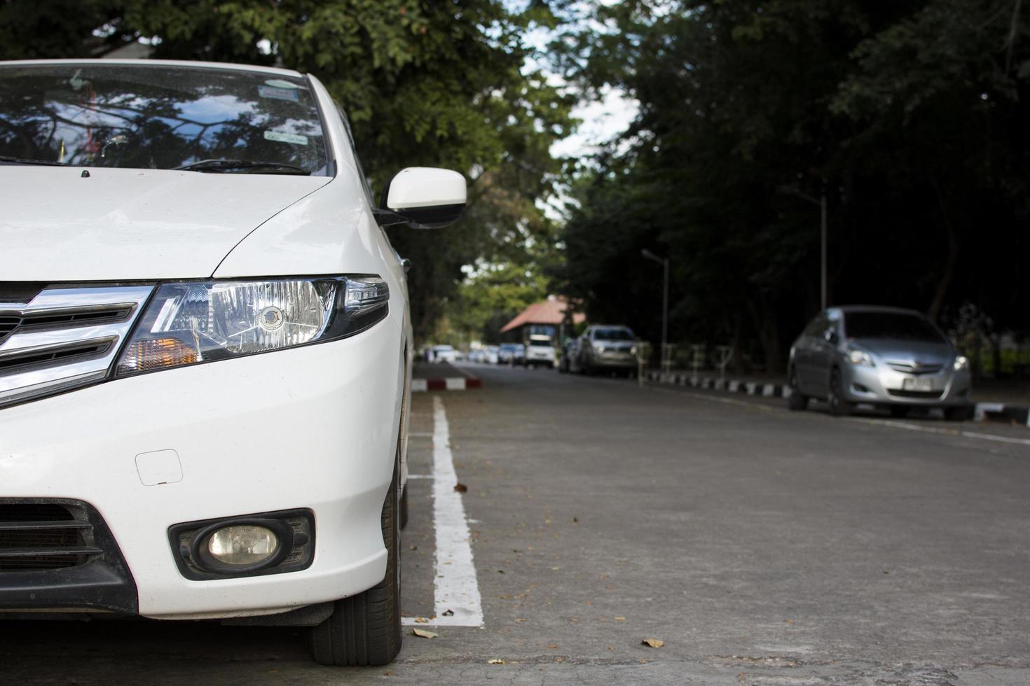 White car parked on the street. photo