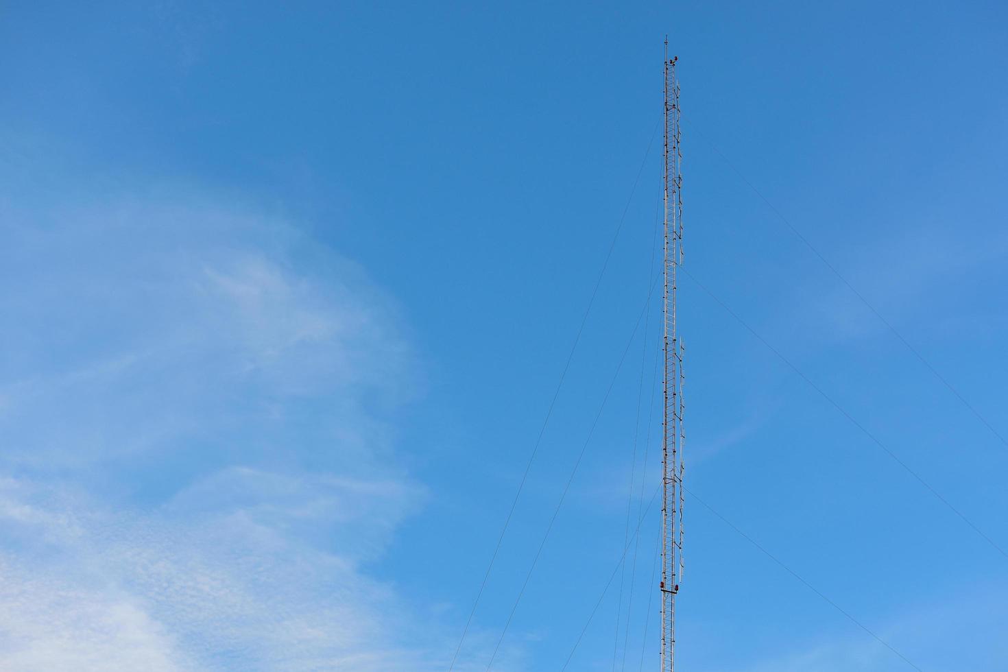 Phone antenna with blue sky background. photo