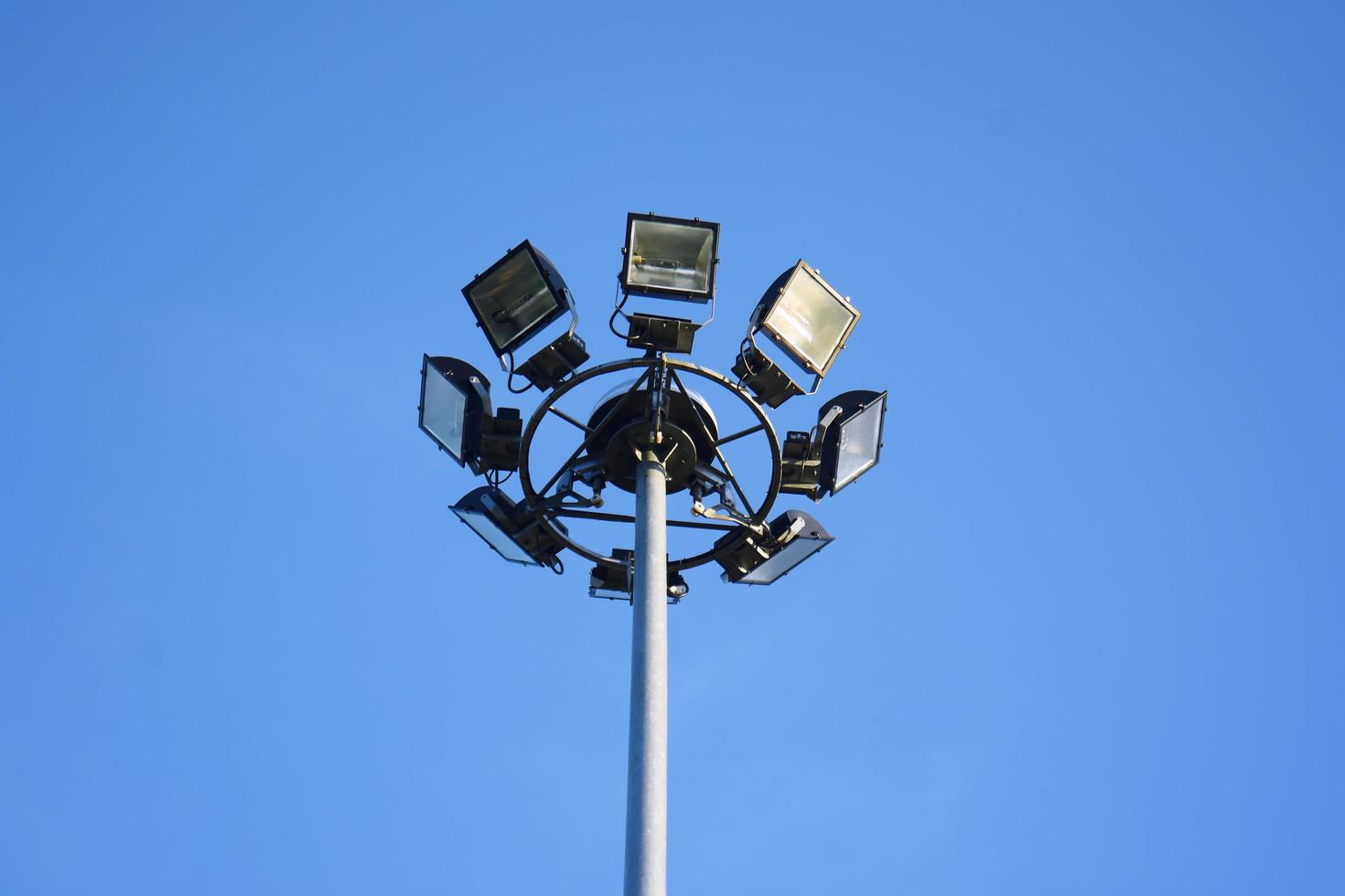 Football lights on a blue sky photo