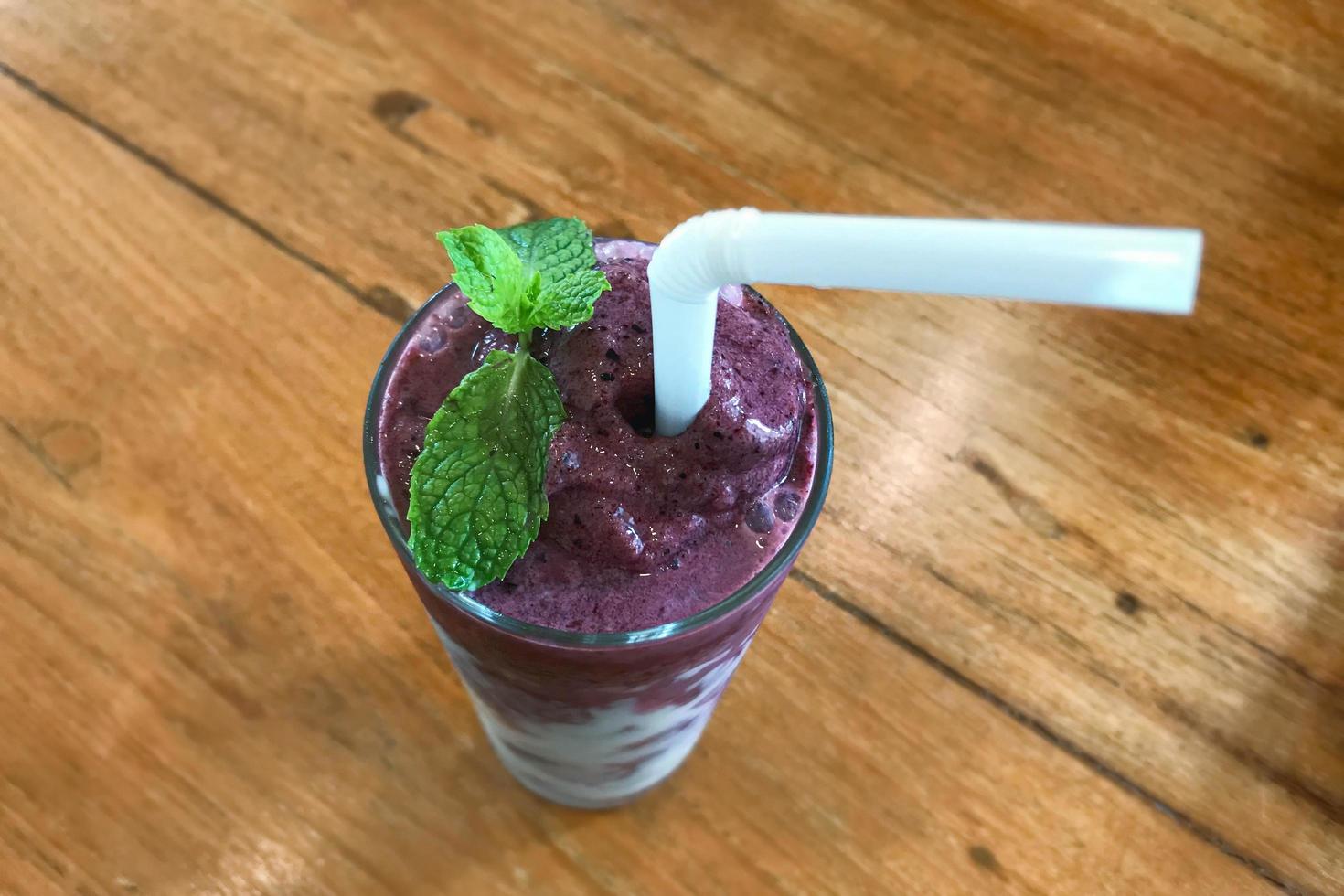 Glass of blueberry smoothie with mint photo