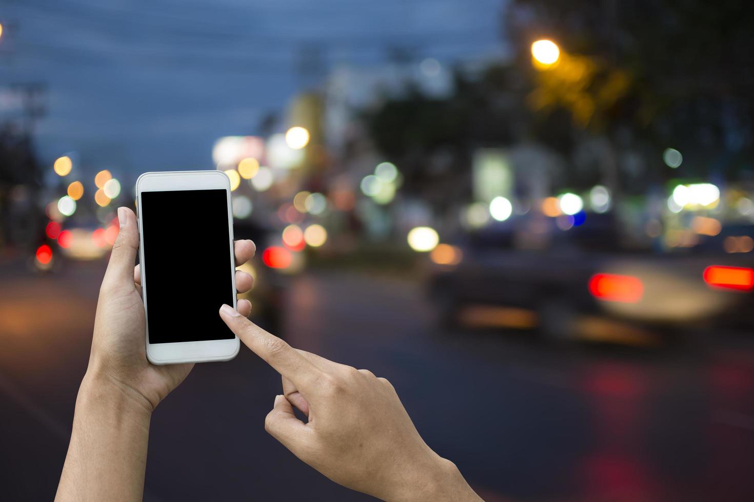 Hand holding smartphone on blur background transport. photo