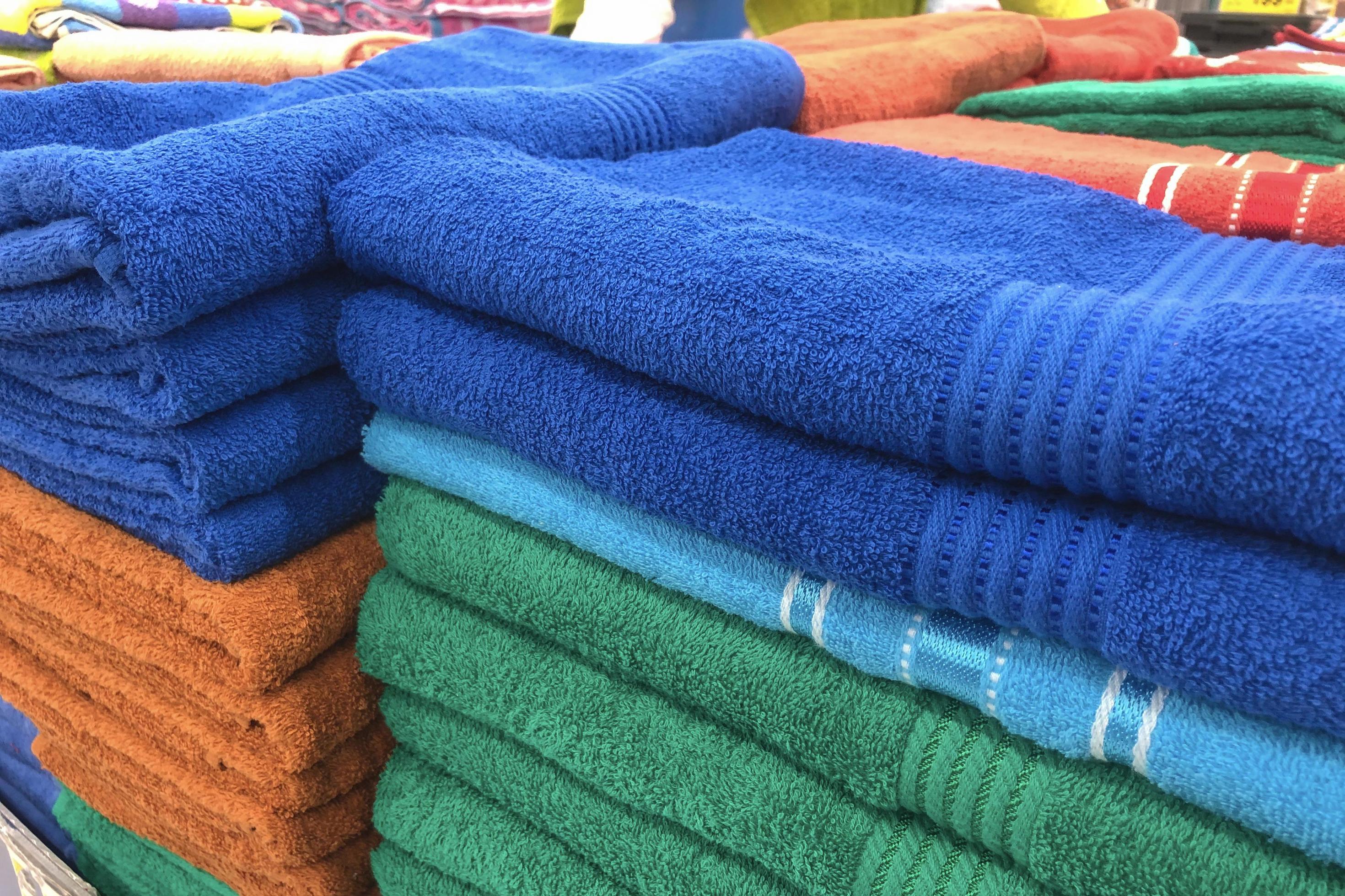 Folded towels for sale in the mall. 1862657 Stock Photo at Vecteezy