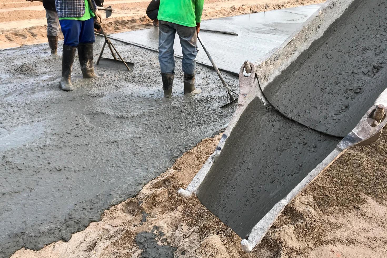 Workers smoothing cement photo