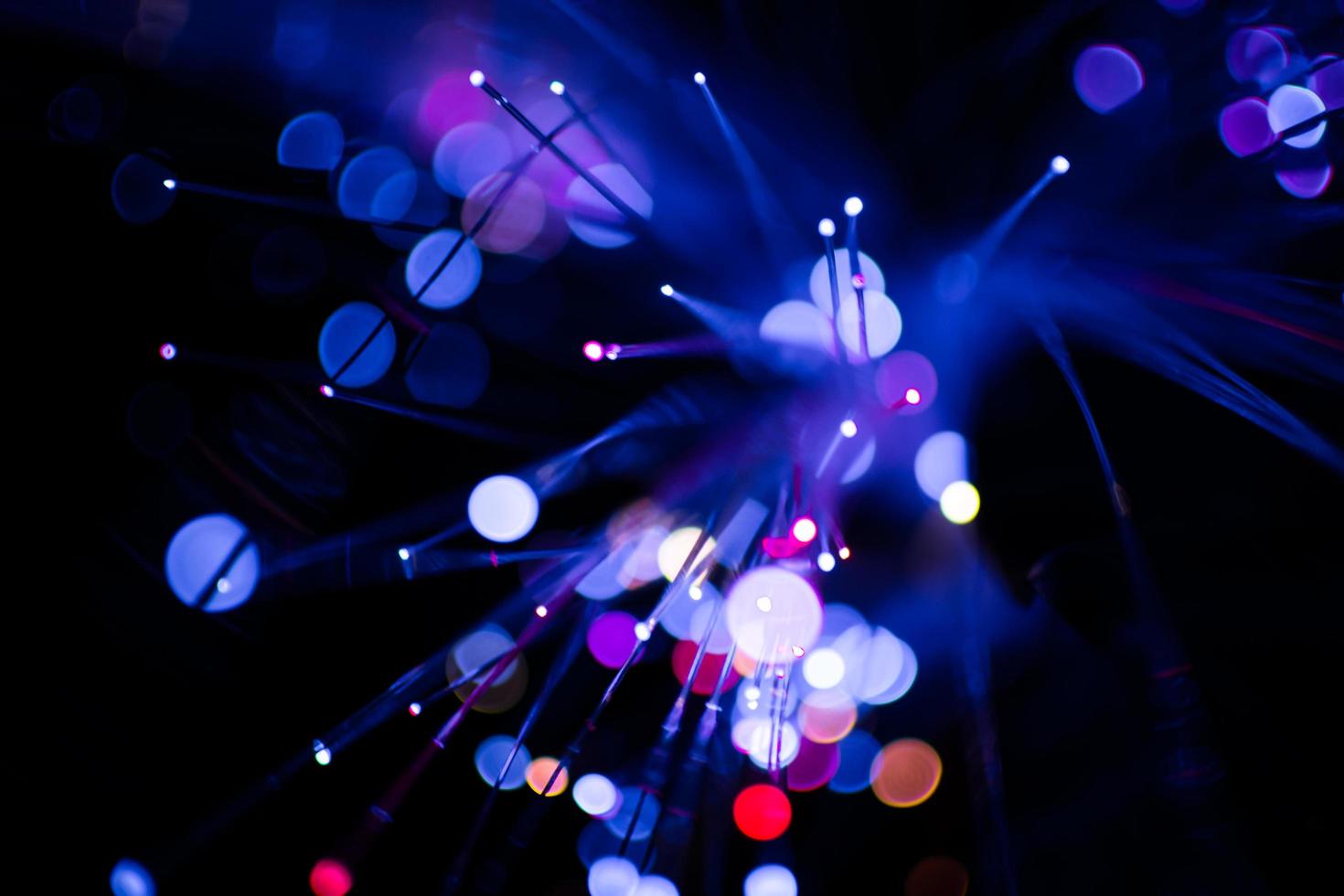 Colorful bokeh purple light celebrate at night, defocus light abstract background. photo