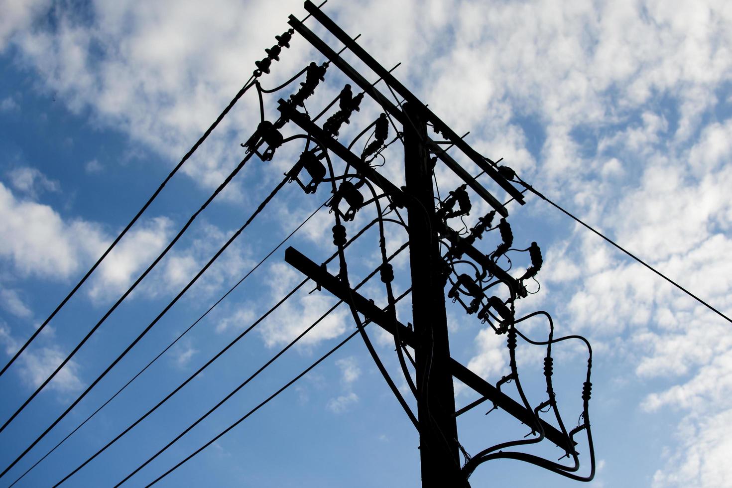 Telephone lines against a blue sky photo