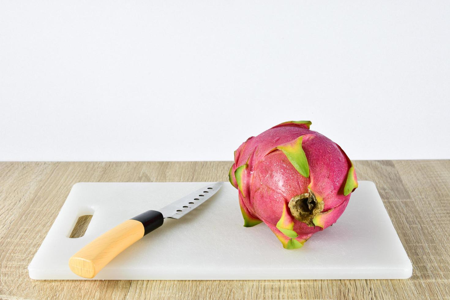 A dragon fruit on wood background photo