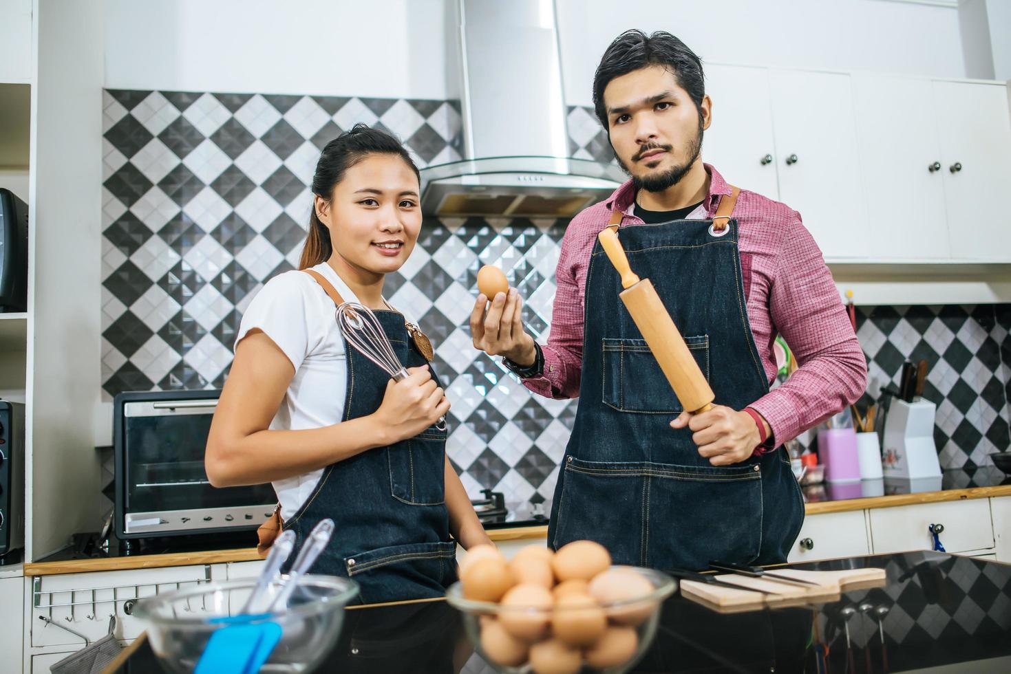 A happy young couple cooking together at home photo