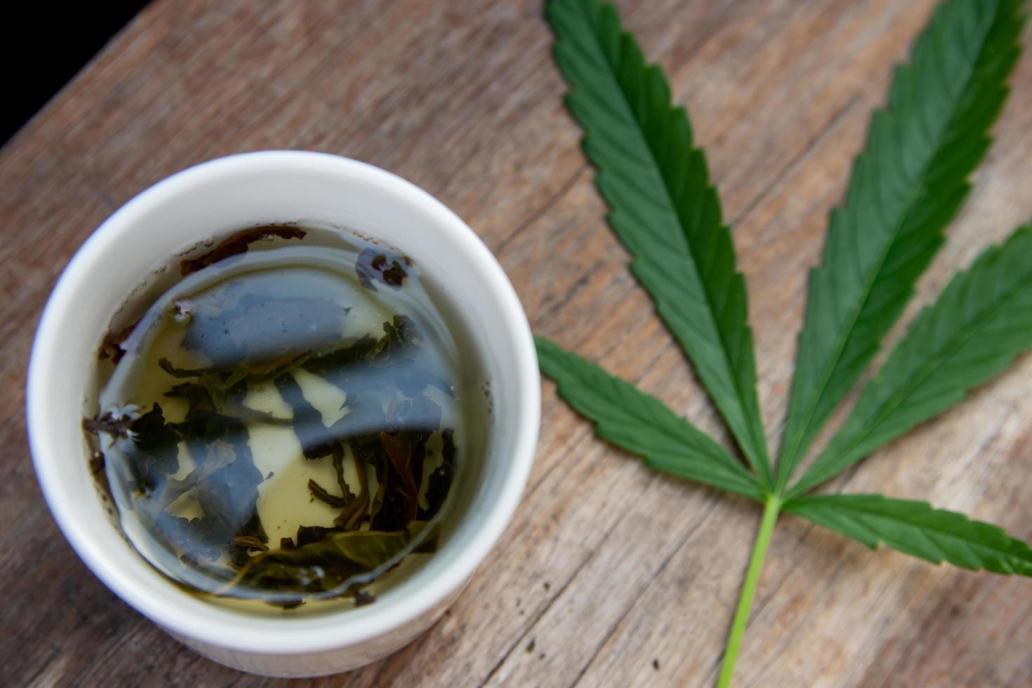 Green marijuana leaves and marijuana tea photo