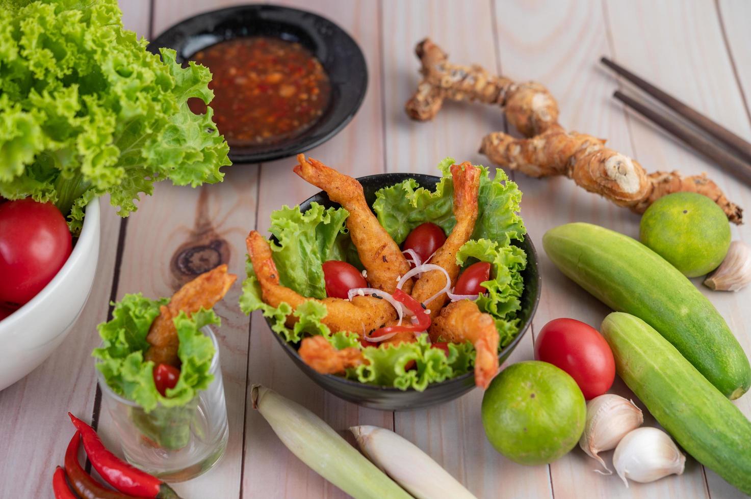 Shrimp deep fried in batter on salad photo