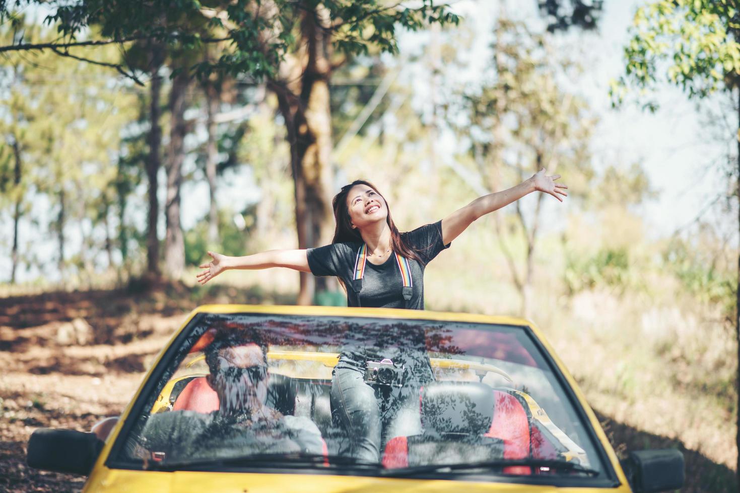 Happy couple enjoying the top down in convertible photo