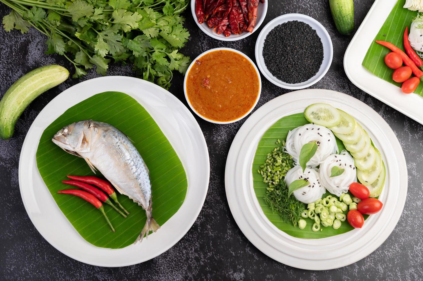 Mackerel fish with rice noodles and vegetables photo