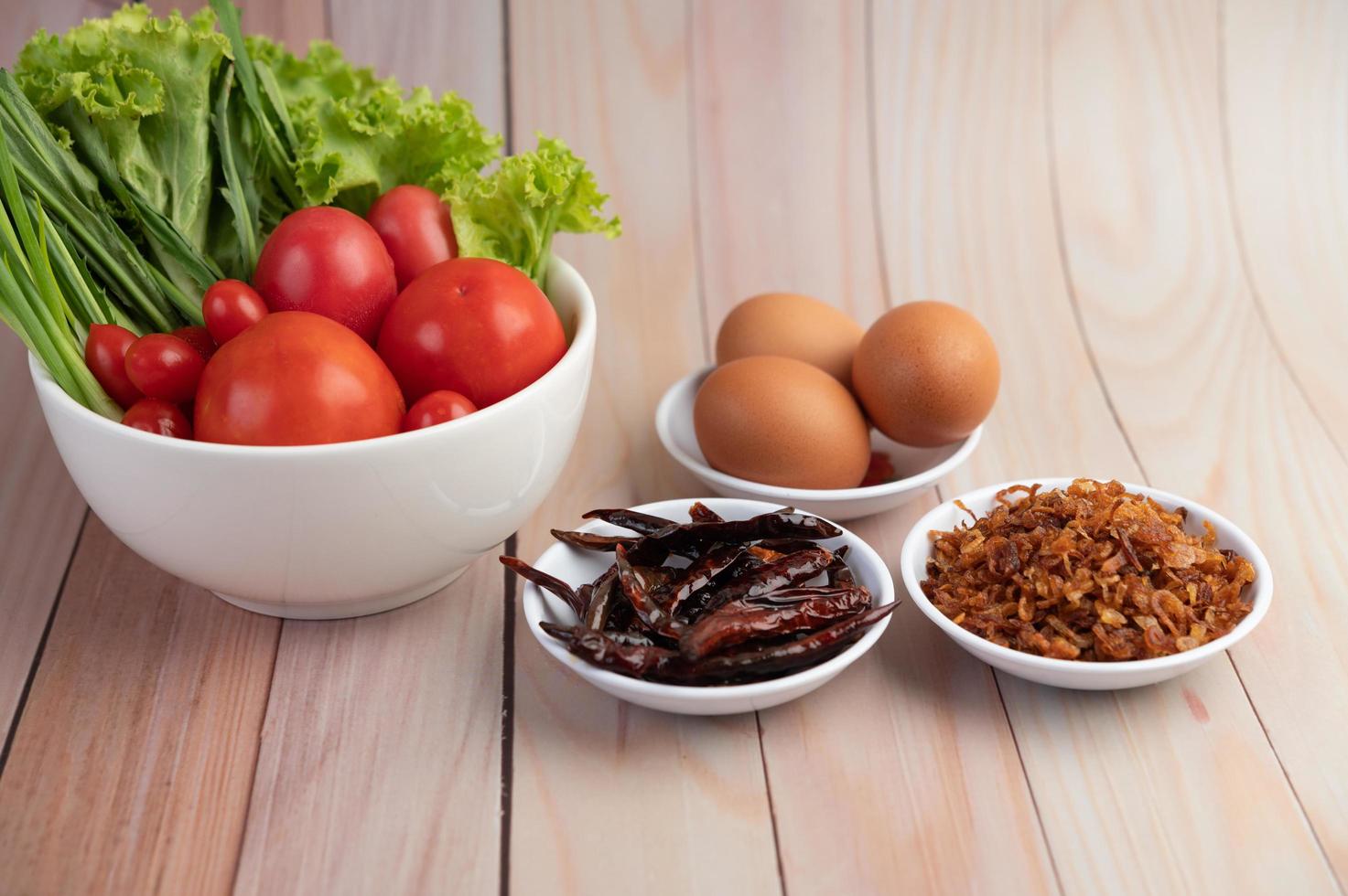 Fried onions, peppers, eggs, tomatoes, salad and spring onion photo