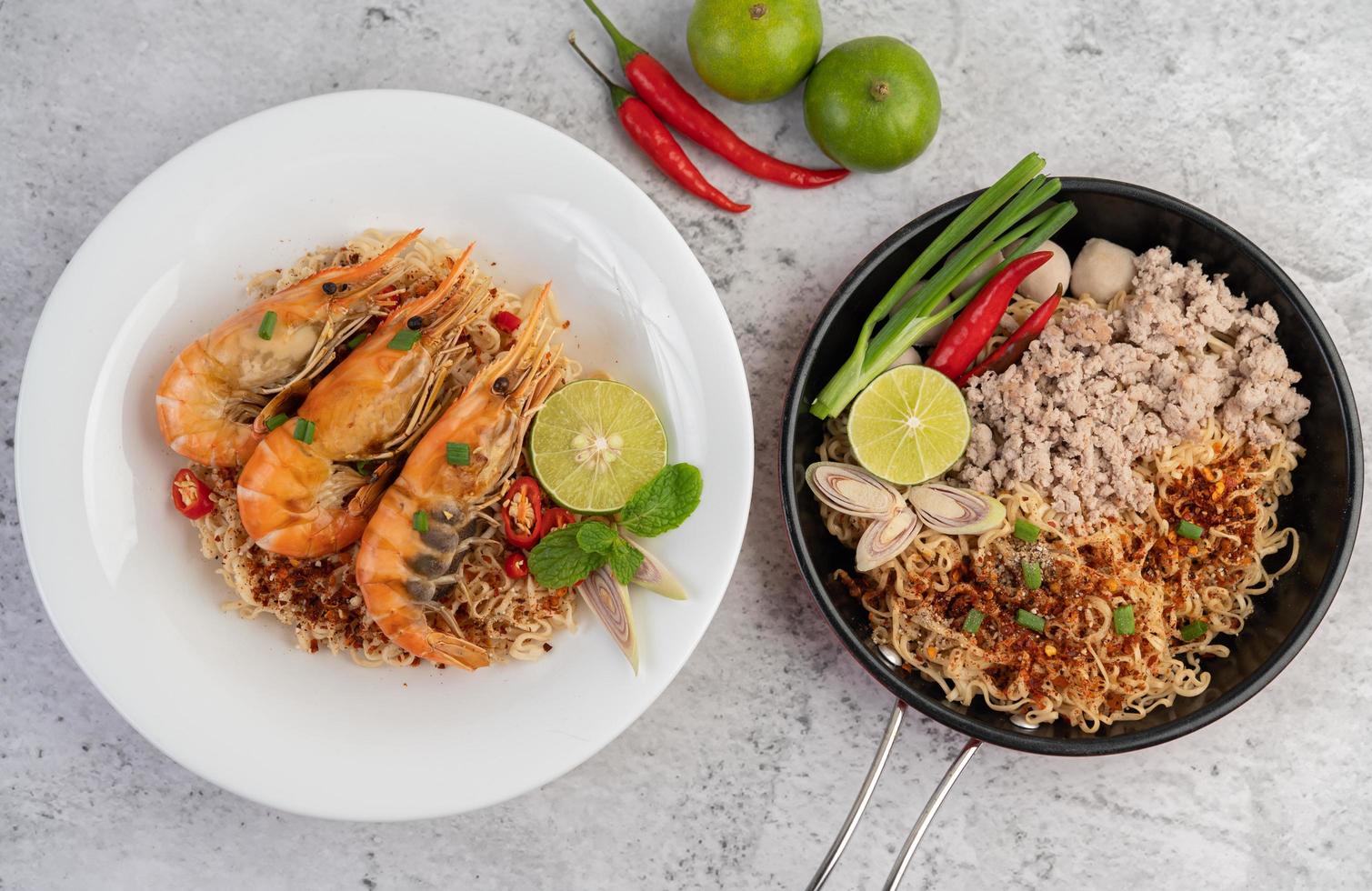 fideos y camarones en un plato blanco foto