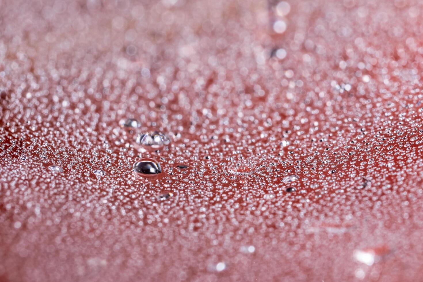 Water droplets on red surface photo