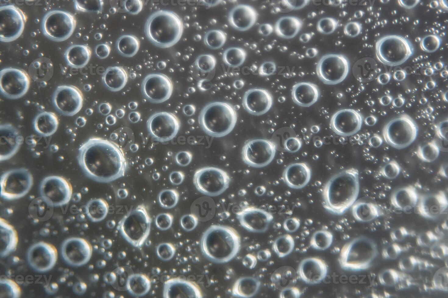Water bubbles on a glass surface photo
