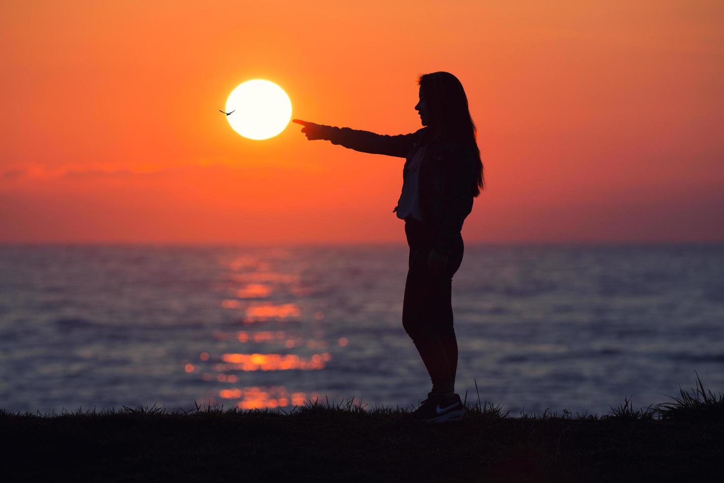 Girl touching the sun photo