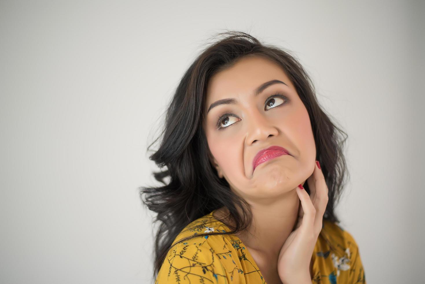 Young woman giving expressive face on white background photo