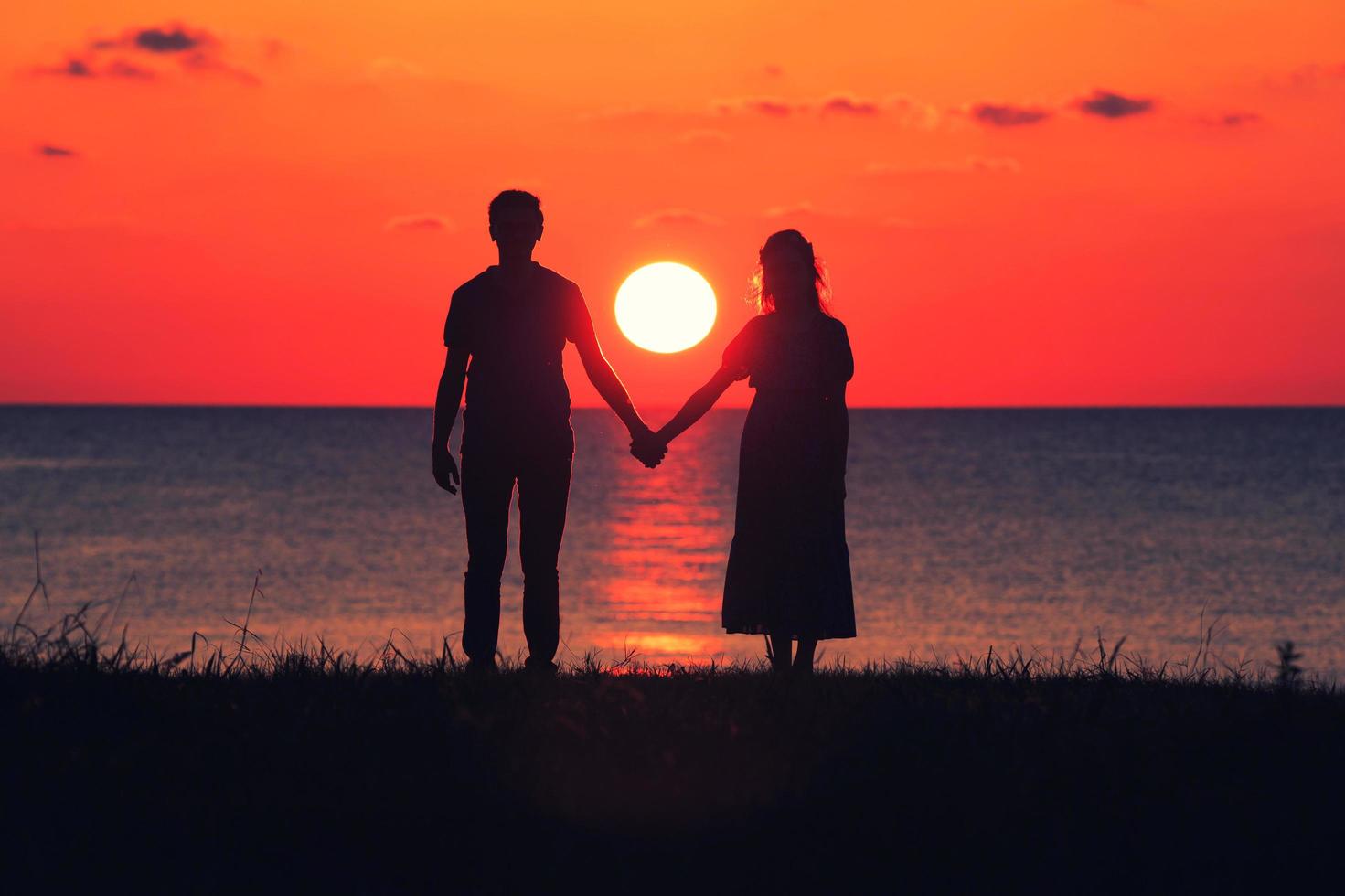 Silhouette of a couple at sunset photo