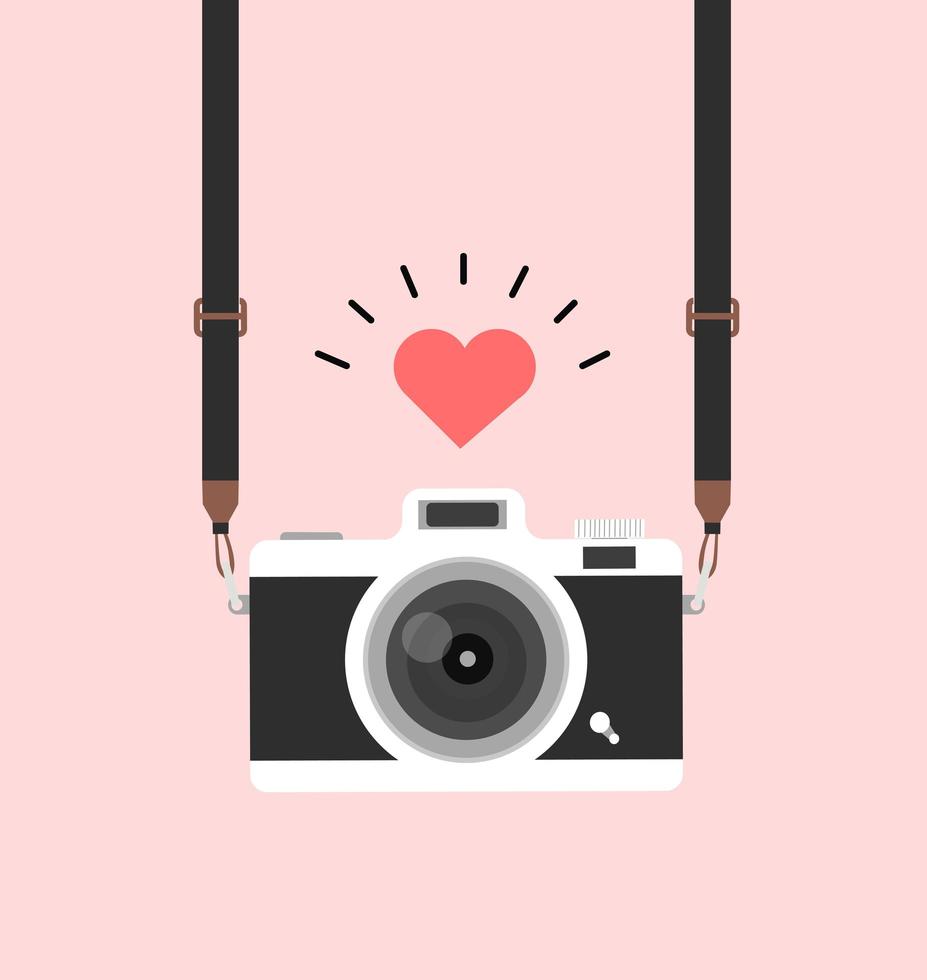 hanging vintage camera with heart on pink background vector