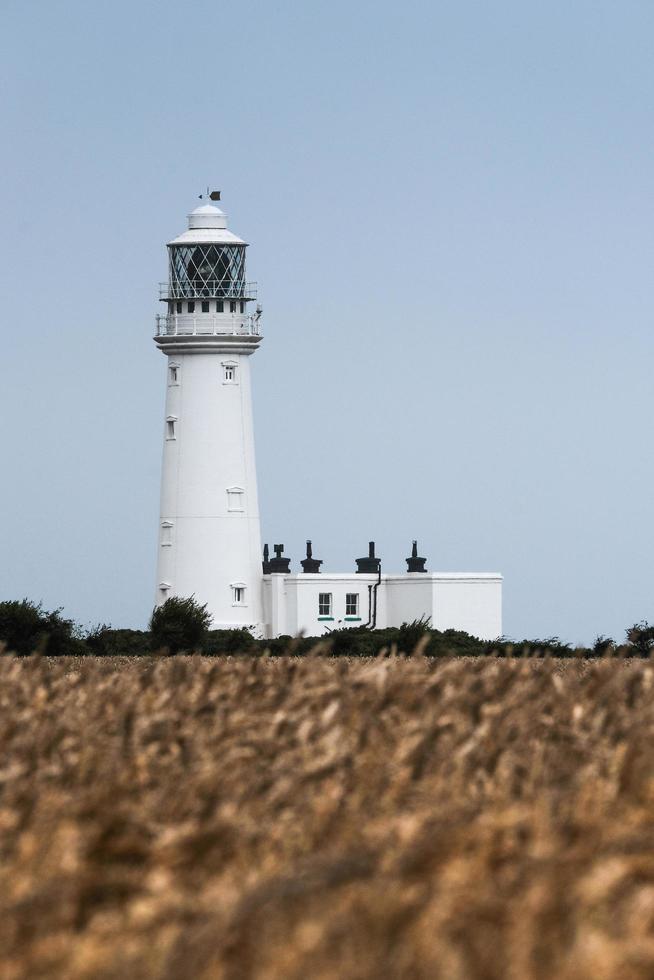 Lighthouse in a field photo