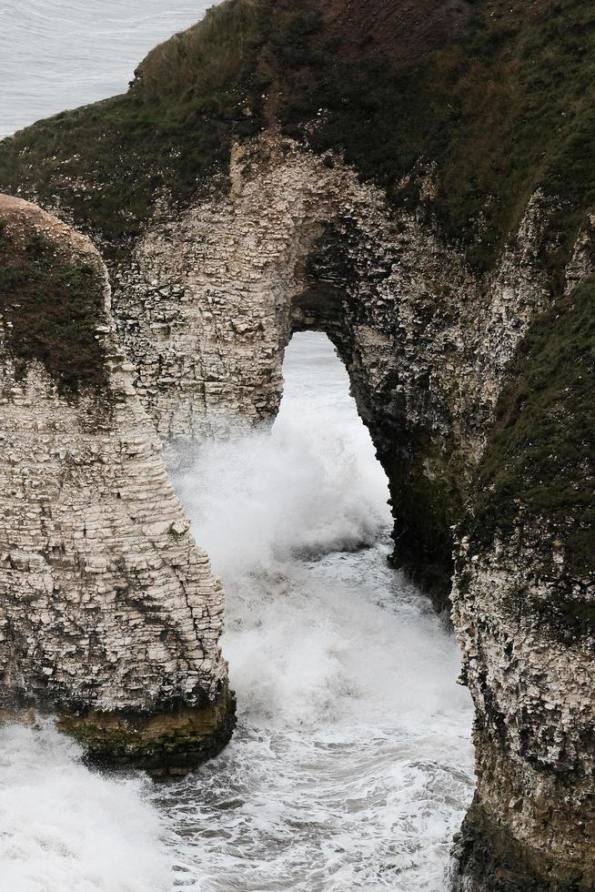 Water falls between rocky mountain during daytime photo