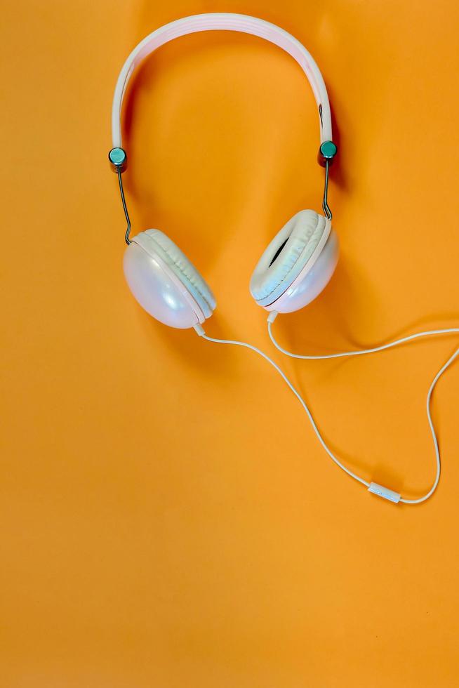 Music headphones on orange background photo