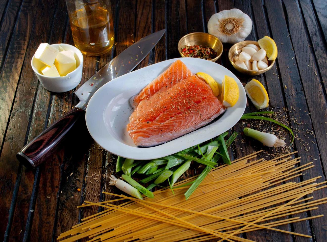 Steamed salmon beside sliced of lemon photo