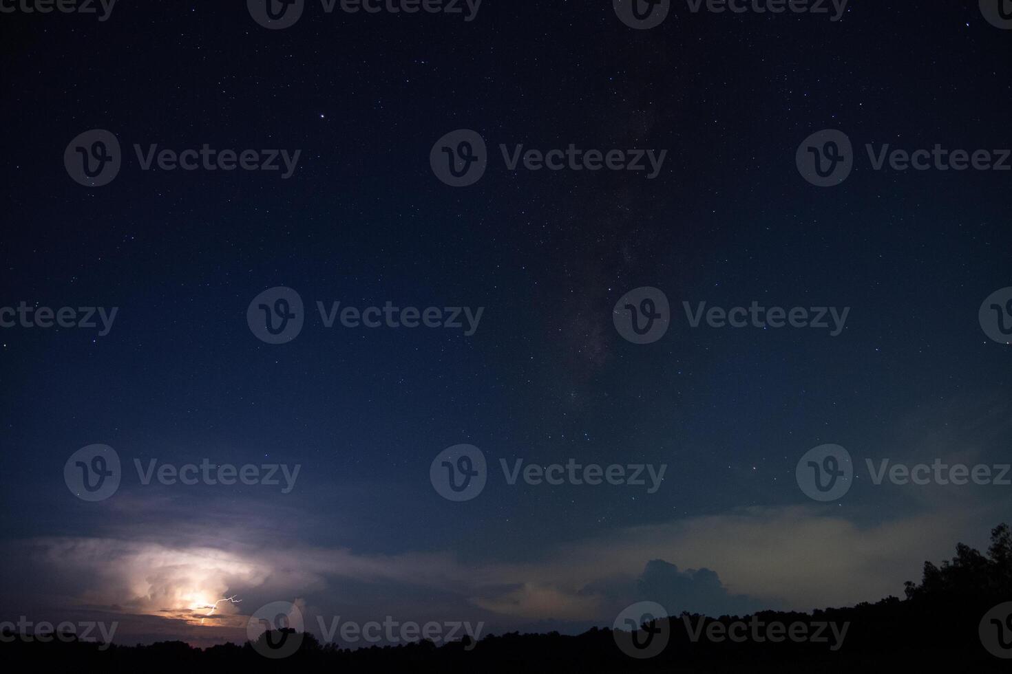 The milky way and the moon over the field photo