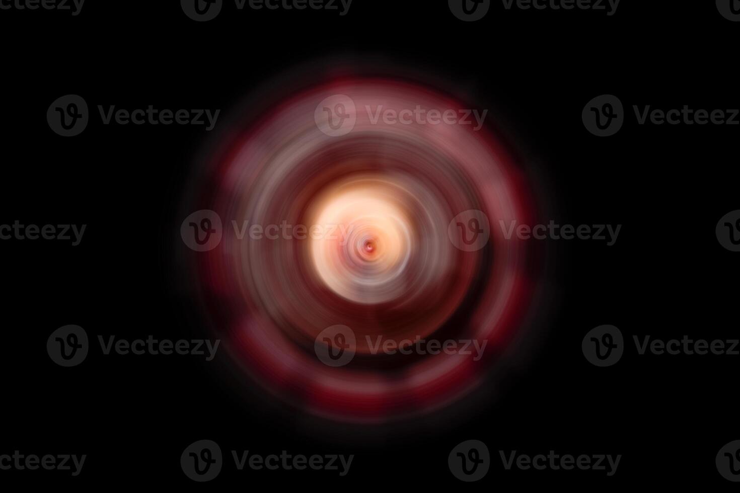 A red and black spinning object on a black background photo