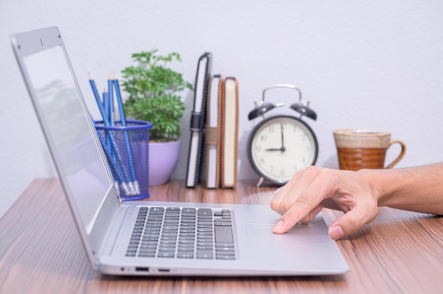 Hand of a person using a laptop computer photo