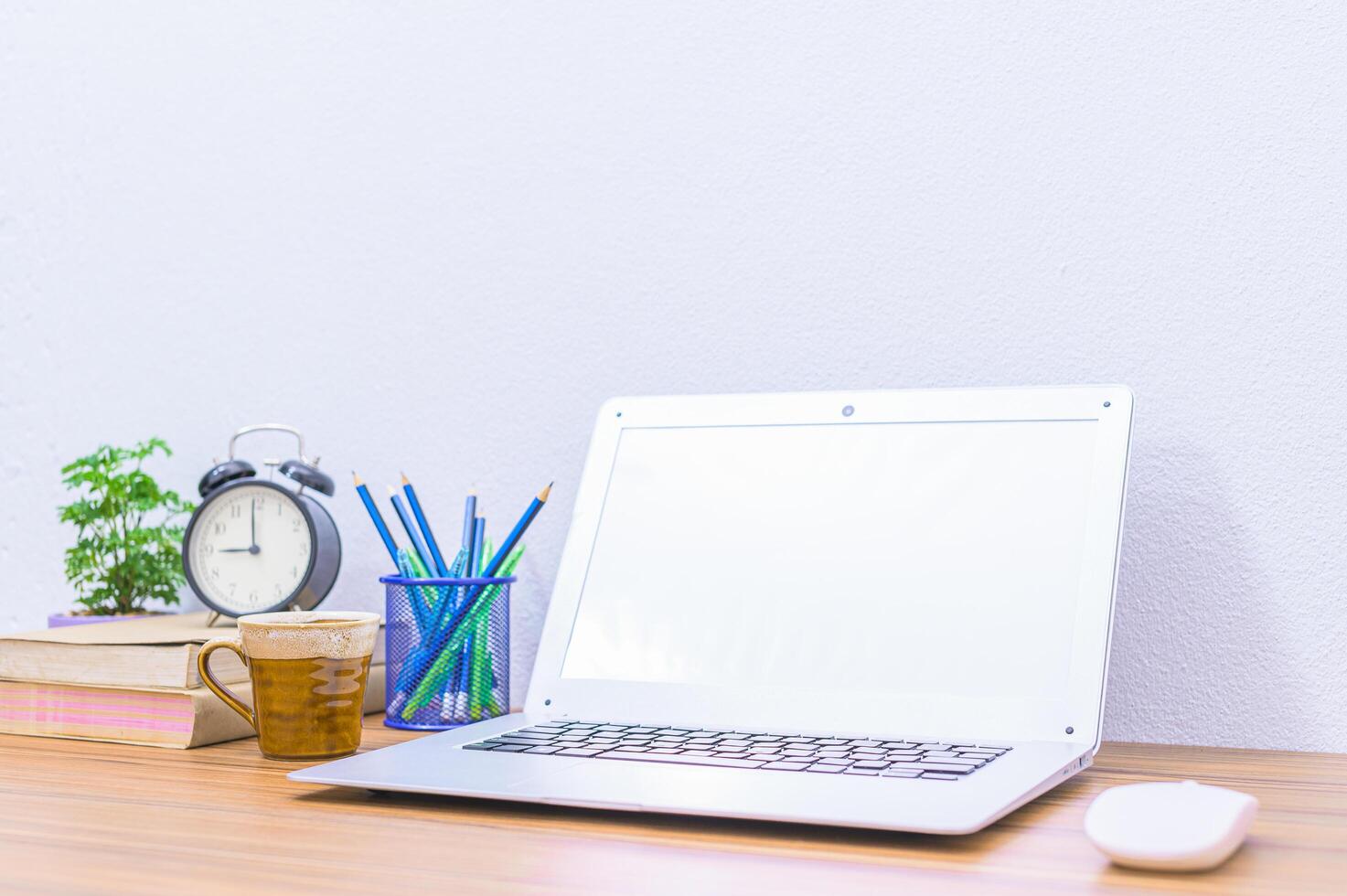 Laptop and other objects on the desk photo