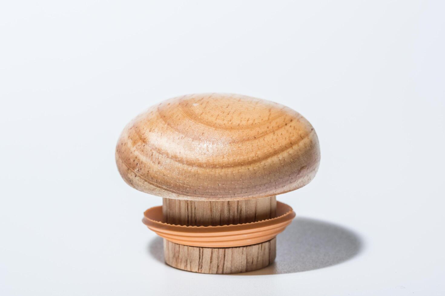 Wooden bottle cap on white background photo