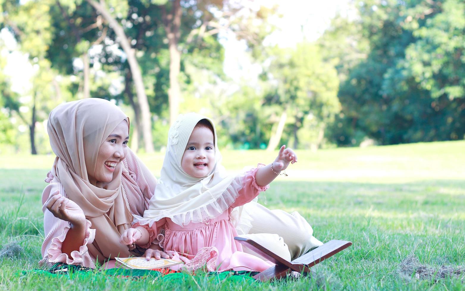 Muslim mothers and daughters enjoy their holidays in the park photo