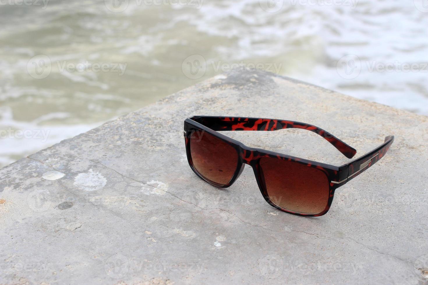 Sunglasses near a pool photo