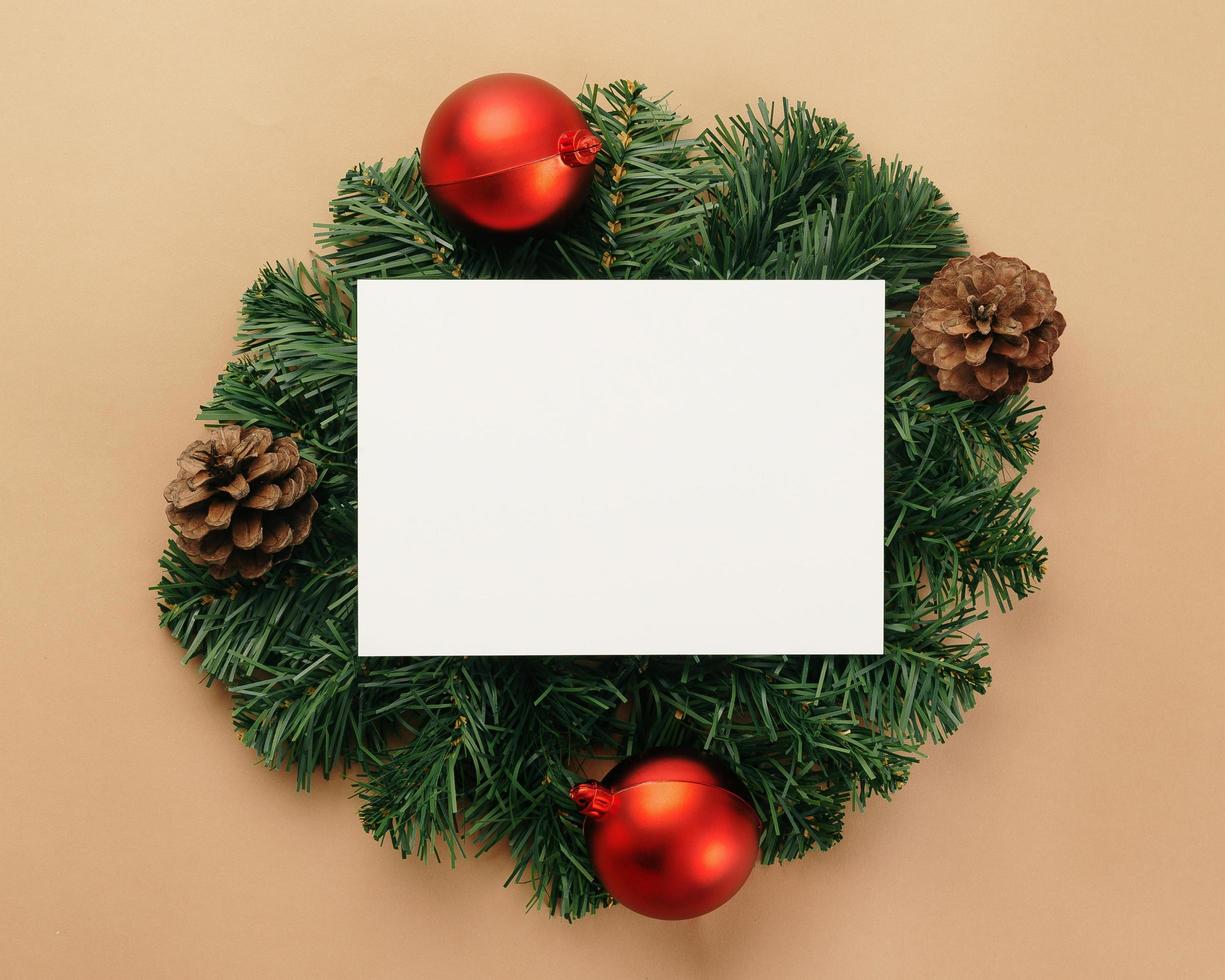 Merry Christmas greeting card mockup template with pine leaves decorations photo